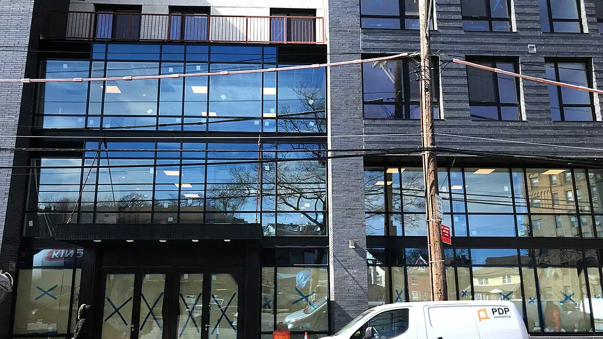 Glass curtain wall and ground-floor storefront on a new New York building
